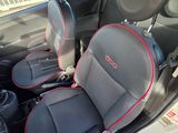 two seats in the back of a car with red trims