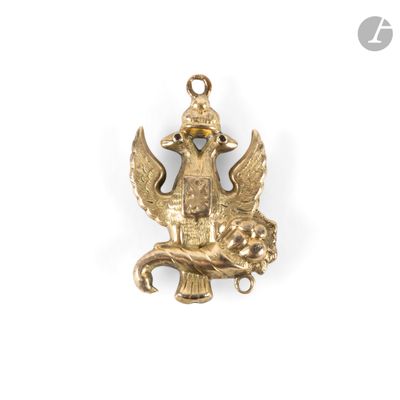 an image of a gold plated pendant with a bird on it