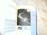 a book open on a bed with a drawing on it