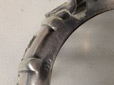 a close up of a silver ring with a bird on it
