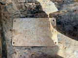 a plaque on the side of a stone wall