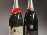 two bottles of champagne sitting next to each other on a table