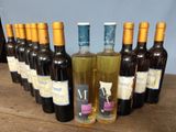 several bottles of wine are lined up on a wooden table