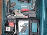 a blue tool box with tools in it on a table