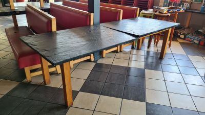 a table and chairs in a restaurant with tiled flooring