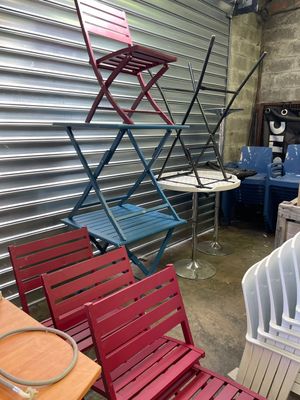 many different colored chairs and tables in a room