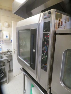 a picture of a kitchen with two ovens and a sink