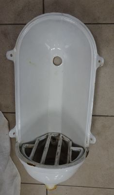 des toilettes dont l'évacuation se trouve au milieu du sol