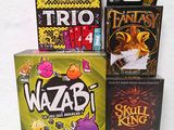 three board games sitting on top of a table next to each other