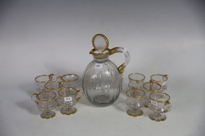 a glass pitcher and glasses on a white table