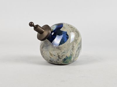 a small blue and white object on a white surface