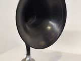 a black and silver speaker sitting on a white table