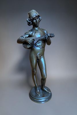 bronze statue of a boy with a mandolin