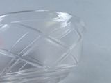 a clear glass bowl with a red apple inside of it
