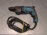 a cord connected to a drill on a table