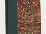 an old book with a brown cover and a green cover
