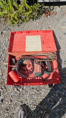 a red box with wires and wires in it on the ground