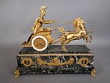 a statue of a man riding on a horse drawn carriage