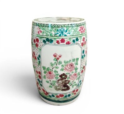 a white vase with flowers on it on a white surface