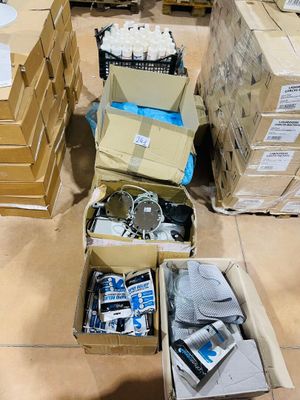several boxes of electronics are stacked on the floor in a warehouse