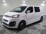 the white van is parked on a checkered tile floor