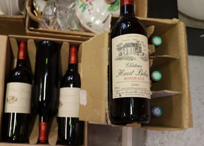 many bottles of wine sitting in a box on the counter