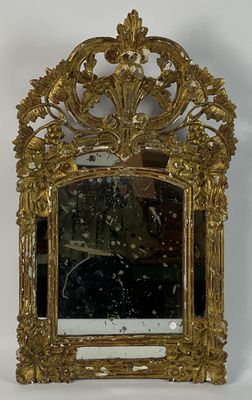 a gold frame with a mirror on it on a table