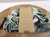 an image of a bag with a bird on it sitting on top of a wooden table