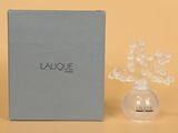 a close up of a bottle of perfume next to a box