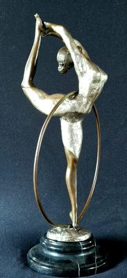 statue of a woman holding a hula hoop on a black surface