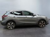 a silver nissan suv parked in a room with a white wall