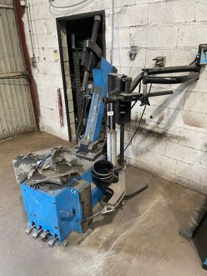 a blue machine that is sitting in a garage