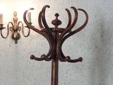 a wooden pole with a candle holder and a chandelier on it