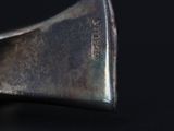a metal object that is sitting on a black surface