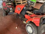 an image of a red lawn mower in a garage