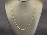 a mannequin with a gold chain on it