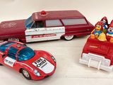 three toy cars sitting next to each other on a table