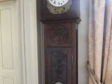 a grandfather clock that is in the corner of a room