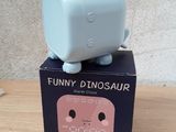 a small blue box with a small blue cat on top of it