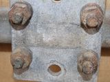 a close up of a piece of metal with nuts on it