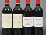 three bottles of red wine sitting next to each other on a table