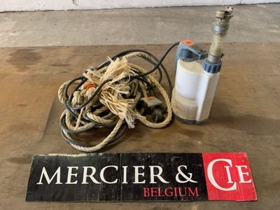a sign that says mercierr and c e next to a bottle of water