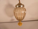 a glass lamp that is hanging from the ceiling