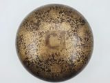a close up of a metal object on a white surface