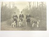 three men and two dogs posing for a picture
