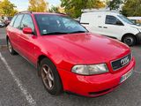 a red car parked in a parking lot next to other cars