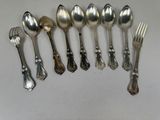 a lot of silver spoons and forks on the table