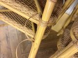 a wicker table with four chairs and a basket on it
