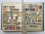 an open book with stamps on it and a ribbon around it