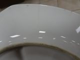 a close up of a dirty toilet seat in a bathroom